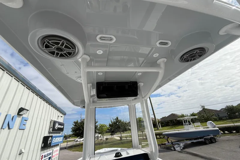 Slide: The Image of 2026 Blazer Bay Makaira 2600 boat T-top with speakers and lighting, outdoor setting. - 31