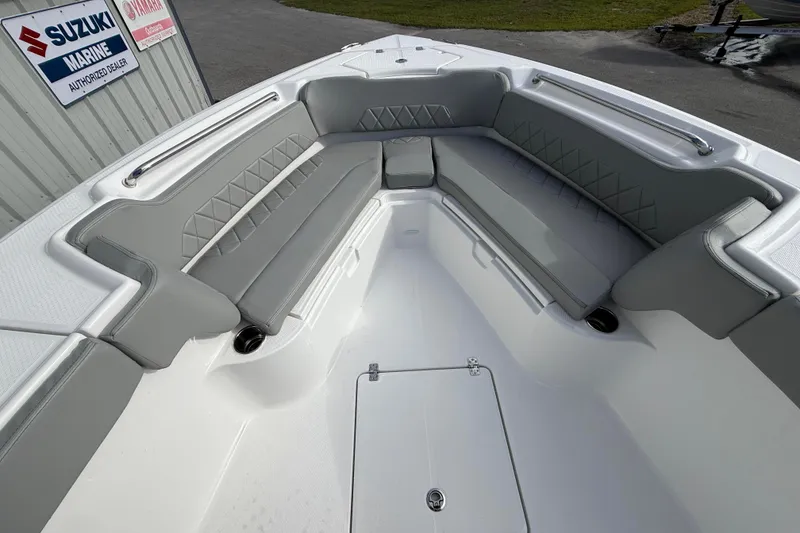 Slide: The Image of 2026 Blazer Bay Makaira 2600 boat interior with gray cushioned seating and storage compartment. - 35