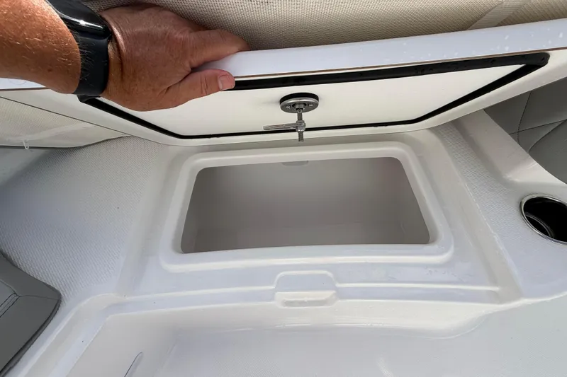 Slide: The Image of 2026 Blazer Bay Makaira 2600 boat storage compartment with open lid and hand. - 37