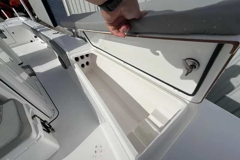 Slide: The Image of 2026 Blazer Bay Makaira 2600 boat storage compartment with cushioned seating and secure lock. - 41