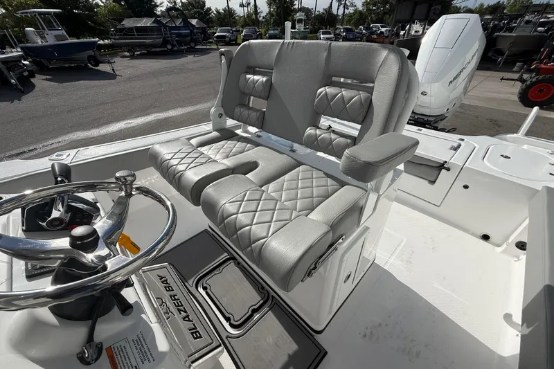 Slide: The Image of Interior of 2026 Blazer Bay Makaira 2600 boat with plush seating and steering wheel. - 43