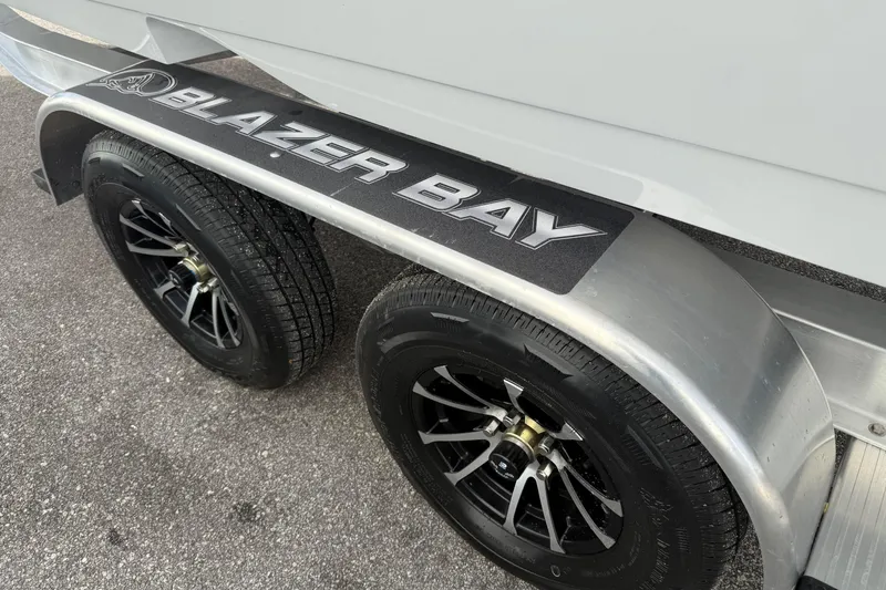 Slide: The Image of Trailer of 2026 Blazer Bay Makaira 2600 with dual black wheels on asphalt. - 45