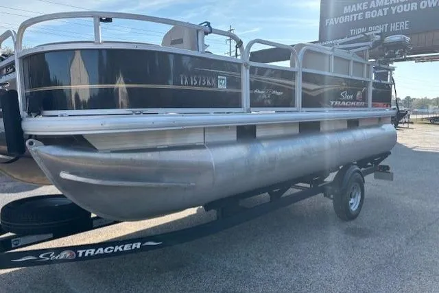 Slide: The Image of 2021 Sun Tracker Bass Buggy 18 DLX pontoon boat on a trailer in a parking lot. - 56