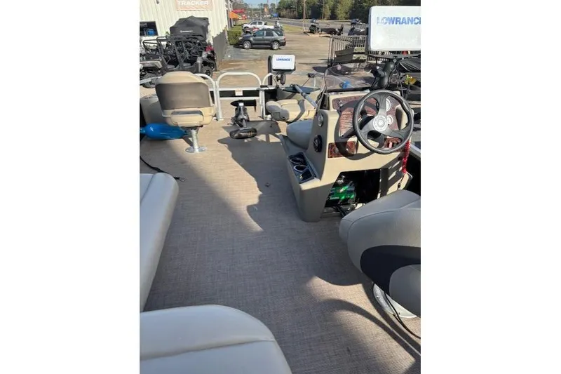 Slide: The Image of 2021 Sun Tracker Bass Buggy 18 DLX interior with steering wheel and seating. - 69