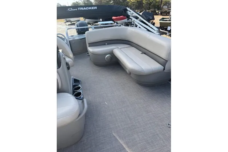 Slide: The Image of 2021 Sun Tracker Bass Buggy 18 DLX pontoon boat interior with gray seating and cup holders. - 72