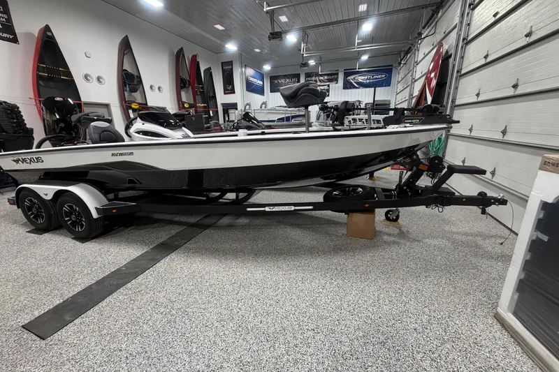 Slide: The Image of 2026 Vexus AVX 2085S boat in showroom, sleek design, on trailer. - 0