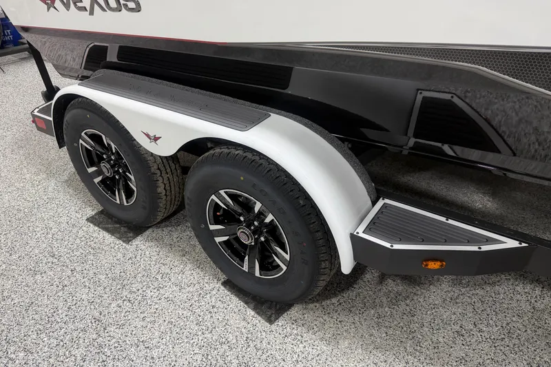 Slide: The Image of Trailer wheels of 2026 Vexus AVX 2085S boat on speckled flooring. - 3
