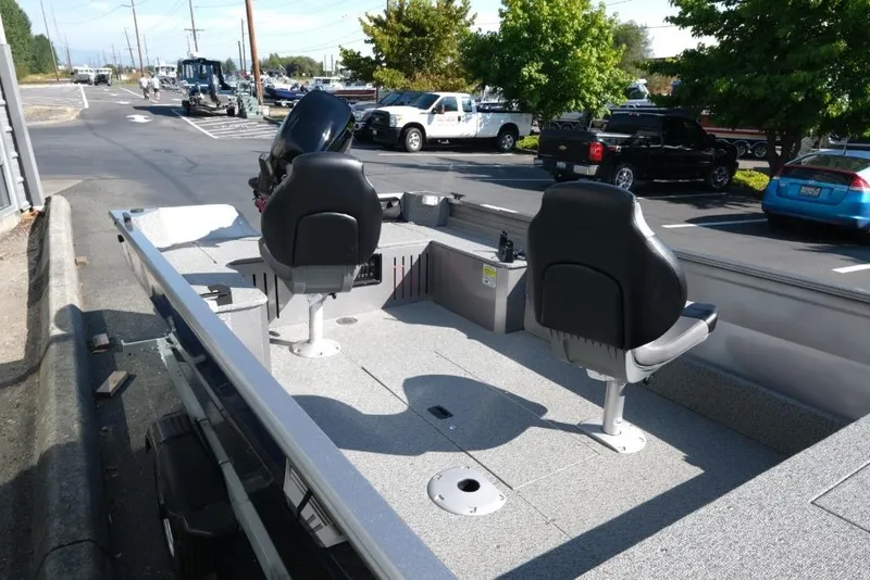 Slide: The Image of 2024 Crestliner 1650 Discovery Tiller boat with dual seats in a parking lot. - 10