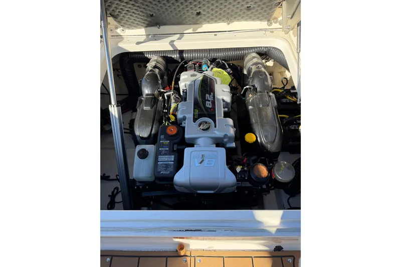 Slide: The Image of Engine compartment of 2023 CHAPPARAL 30 Surf boat, featuring a powerful V8 engine. - 13