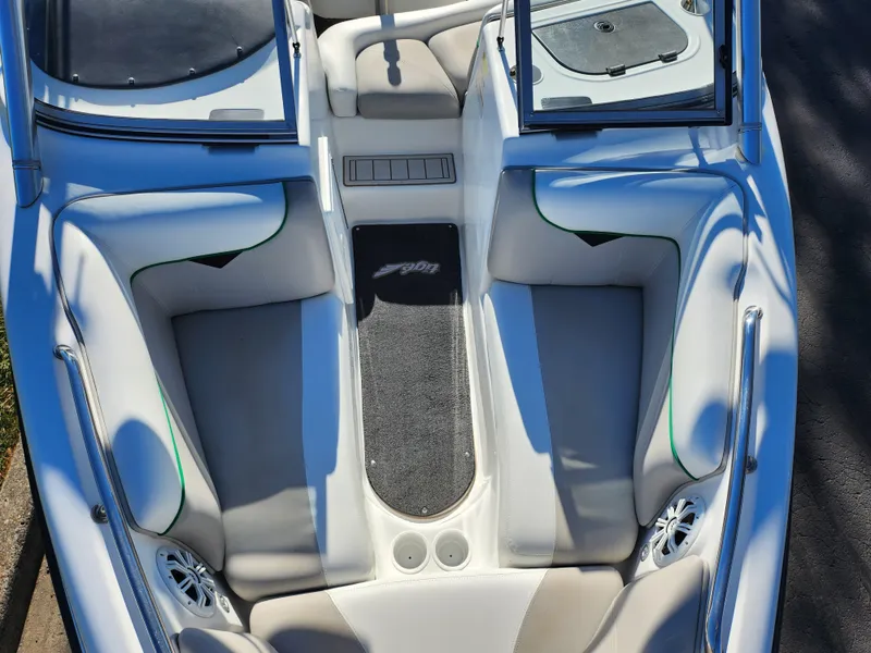 Slide: The Image of 2007 Tigé 22i boat interior with white seating and open windshield. - 17