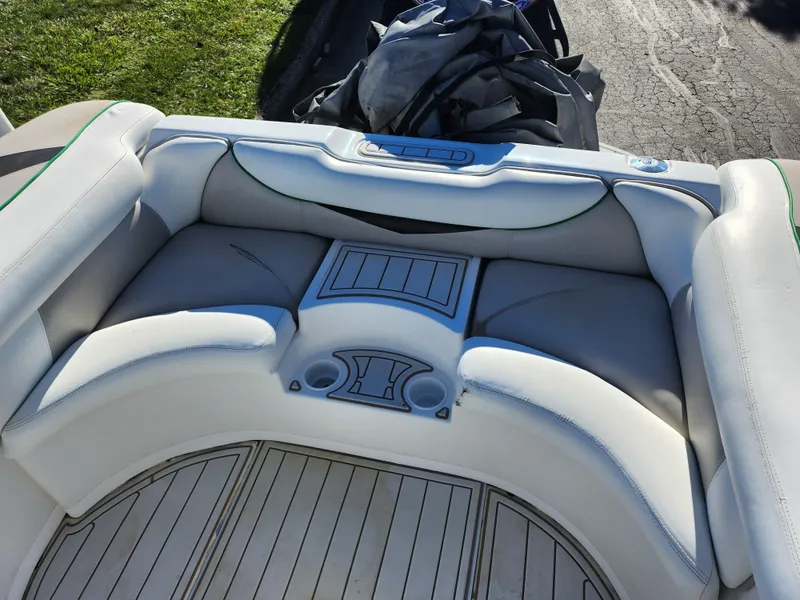 Slide: The Image of 2007 Tigé 22i boat interior with cushioned seating and cup holders. - 21