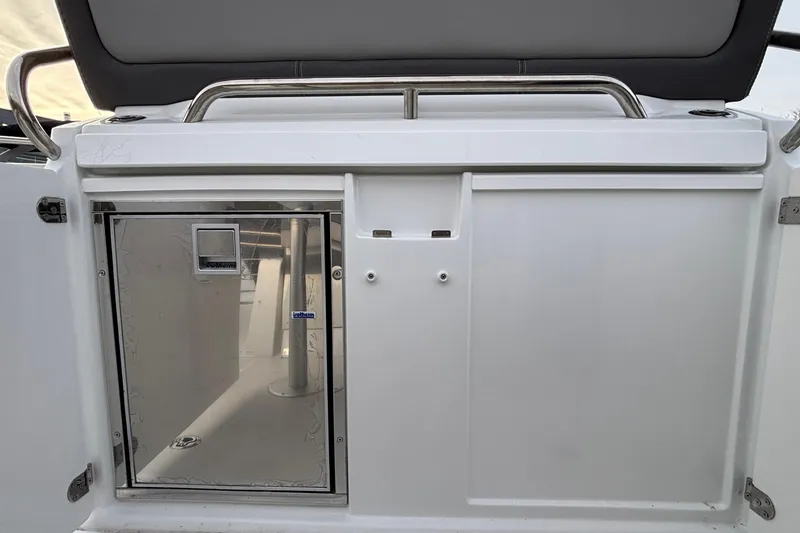 Slide: The Image of 2022 Jeanneau Leader 9.0 CC boat interior with stainless steel fixtures and storage compartment. - 18