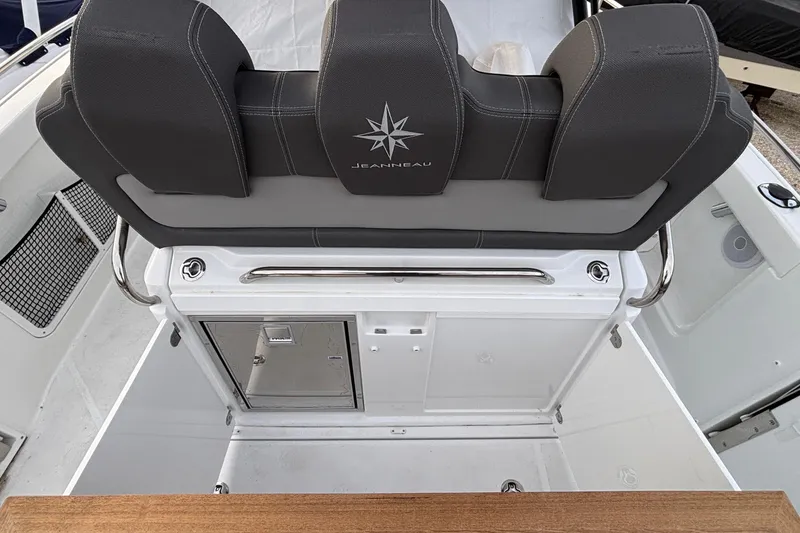 Slide: The Image of 2022 Jeanneau Leader 9.0 CC boat interior with cushioned seating and storage compartments. - 19