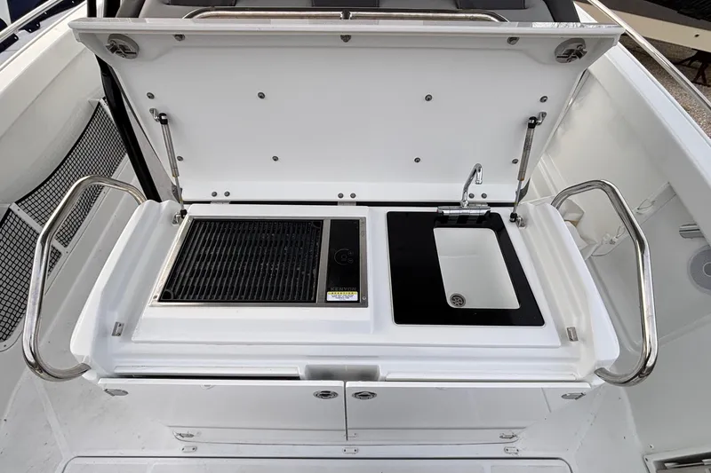 Slide: The Image of 2022 Jeanneau Leader 9.0 CC boat kitchenette with grill and sink. - 21