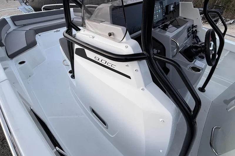 Slide: The Image of 2022 Jeanneau Leader 9.0 CC boat interior with steering console and seating area. - 28
