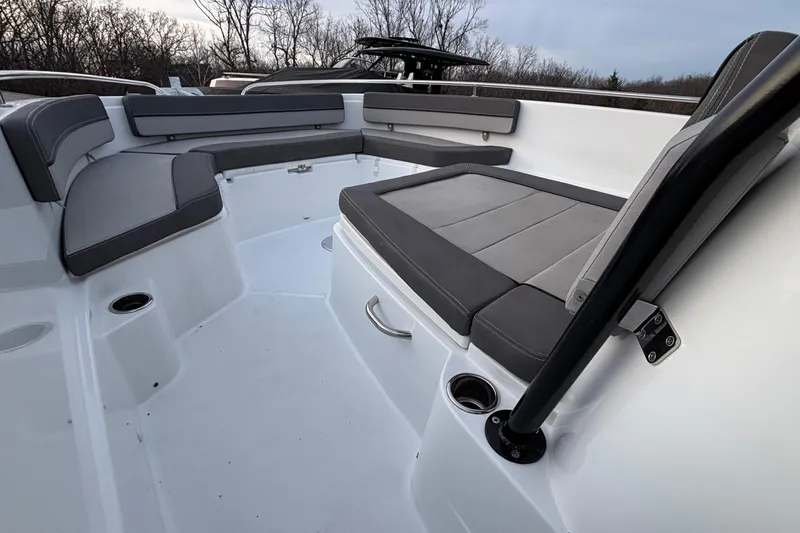 Slide: The Image of 2022 Jeanneau Leader 9.0 CC boat interior with gray seating and cup holders. - 30