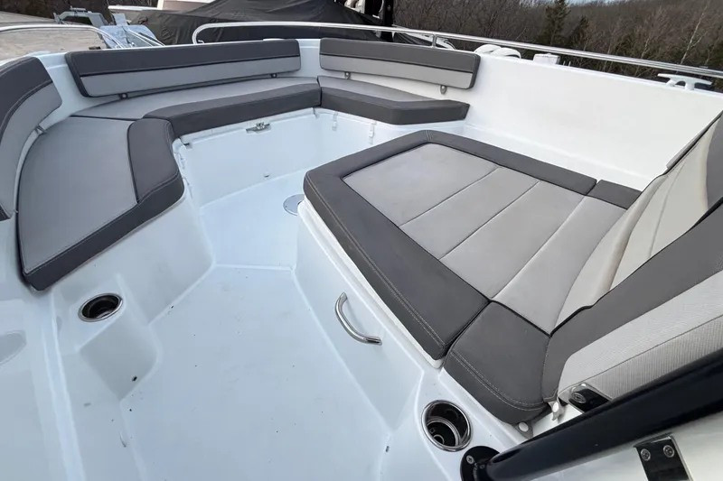 Slide: The Image of 2022 Jeanneau Leader 9.0 CC boat interior with gray cushioned seating. - 32