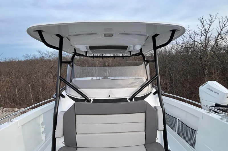Slide: The Image of 2022 Jeanneau Leader 9.0 CC boat with seating and canopy, outdoors. - 34