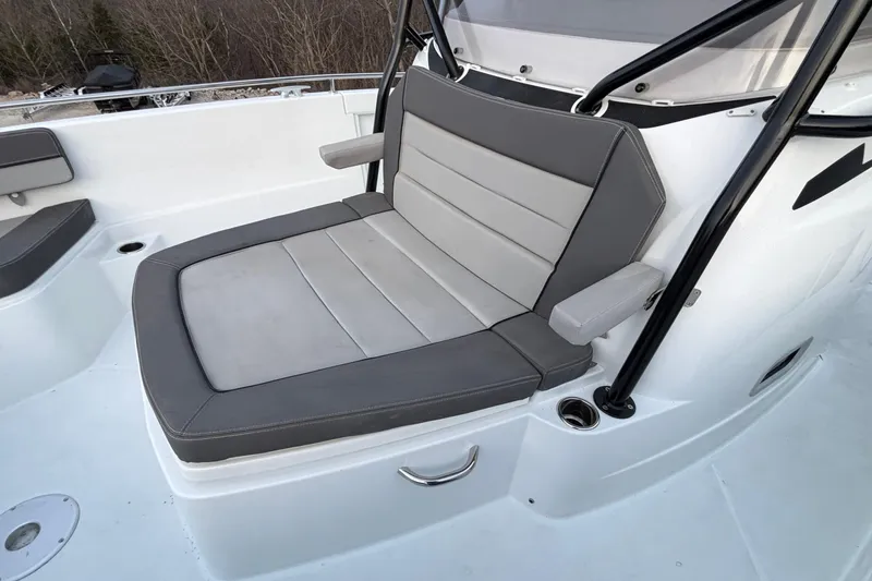 Slide: The Image of 2022 Jeanneau Leader 9.0 CC boat with comfortable gray seating and armrests. - 36