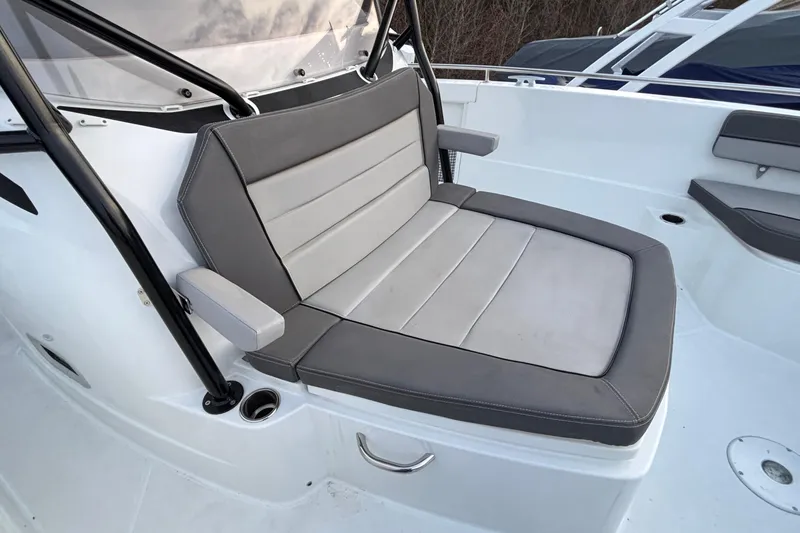 Slide: The Image of 2022 Jeanneau Leader 9.0 CC boat seat with gray upholstery and armrests. - 37