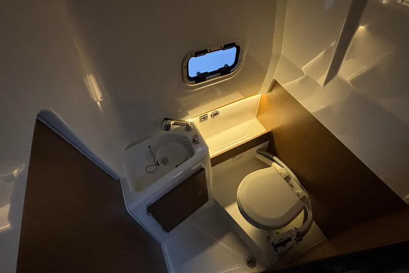 Slide: The Image of 2022 Jeanneau Leader 9.0 CC boat bathroom with sink, toilet, and window. - 44