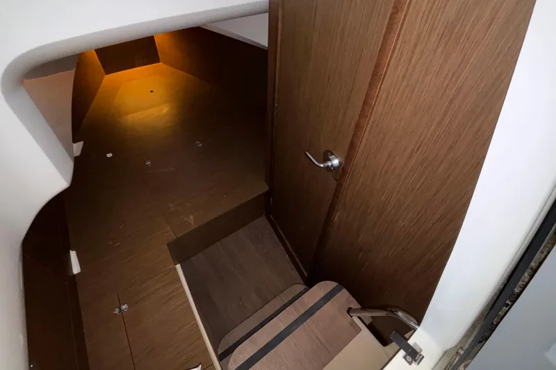 Slide: The Image of 2022 Jeanneau Leader 9.0 CC cabin interior with wooden flooring and door. - 46