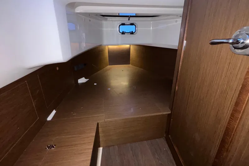 Slide: The Image of 2022 Jeanneau Leader 9.0 CC cabin interior with wood finish and porthole window. - 47