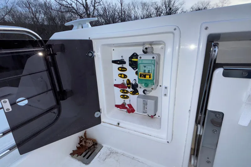 Slide: The Image of Electrical panel on a 2022 Jeanneau Leader 9.0 CC boat, open compartment view. - 48
