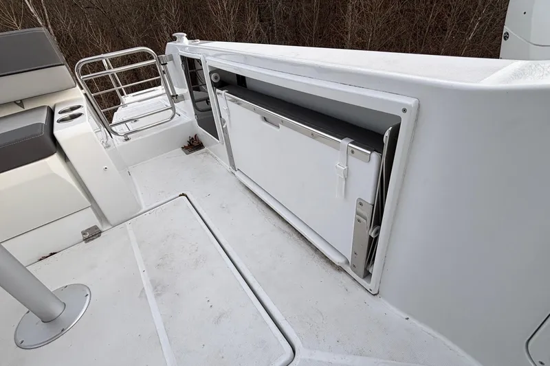 Slide: The Image of 2022 Jeanneau Leader 9.0 CC boat interior with seating and storage compartment. - 7