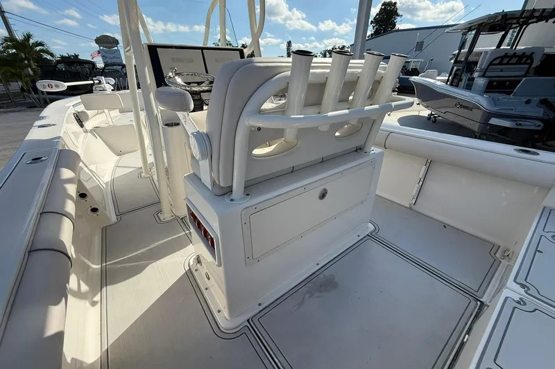 Slide: The Image of 2022 Sea Born LX24 Center Console boat interior with rod holders and seating. - 14