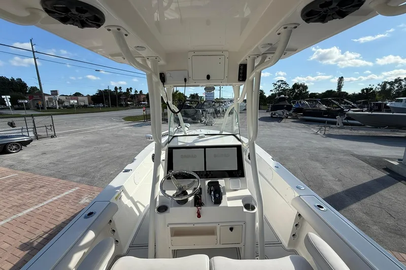 Slide: The Image of 2022 Sea Born LX24 Center Console boat interior with steering wheel and navigation system. - 15