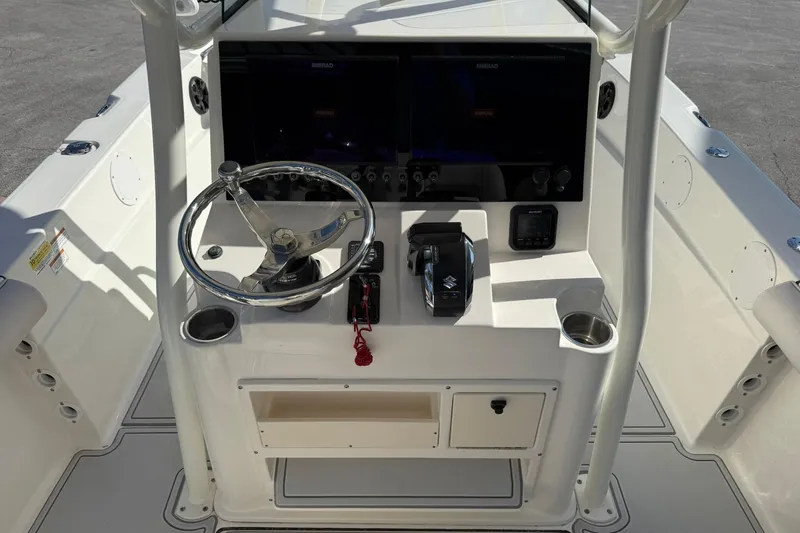 Slide: The Image of 2022 Sea Born LX24 Center Console boat dashboard with steering wheel and controls. - 16