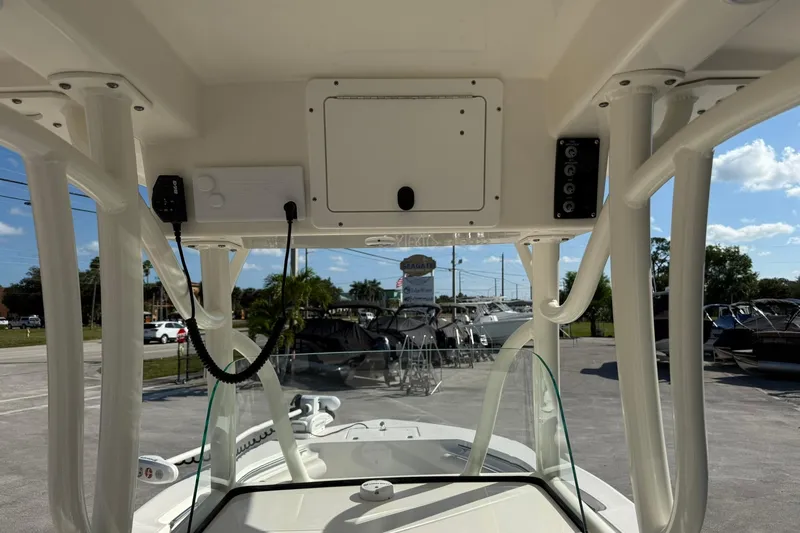 Slide: The Image of 2022 Sea Born LX24 Center Console boat interior with control panel and overhead storage. - 17