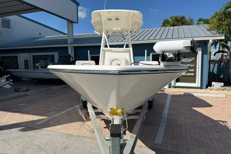 Slide: The Image of 2022 Sea Born LX24 Center Console boat on trailer, parked outside a building. - 3