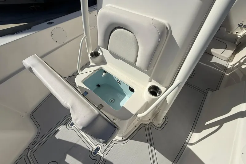 Slide: The Image of 2022 Sea Born LX24 Center Console boat interior with open storage compartment and seating. - 30