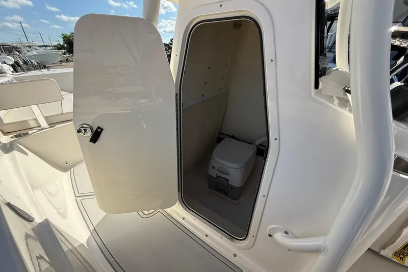 Slide: The Image of 2022 Sea Born LX24 Center Console boat with open cabin door revealing interior space. - 31