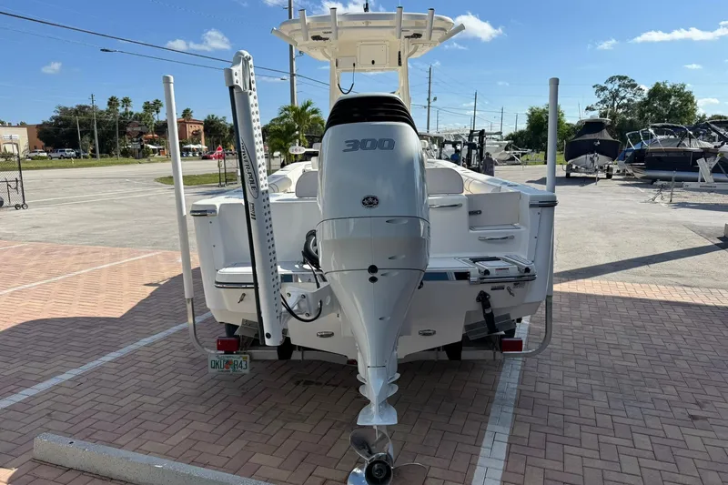 Slide: The Image of 2022 Sea Born LX24 Center Console boat with powerful outboard motor in a sunny marina. - 7