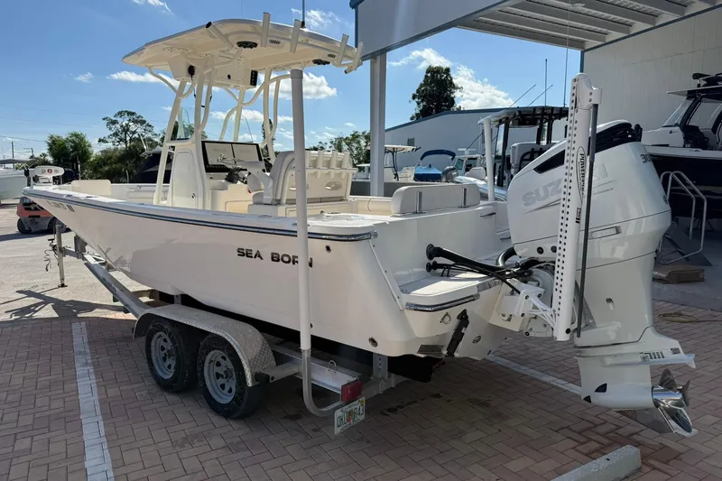 Slide: The Image of 2022 Sea Born LX24 Center Console boat on trailer, parked outdoors. - 8