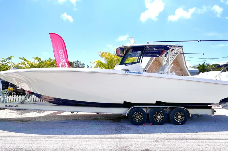 The Image of 2023 Fountain 38 Center Console boat on trailer, displayed outdoors. - 1