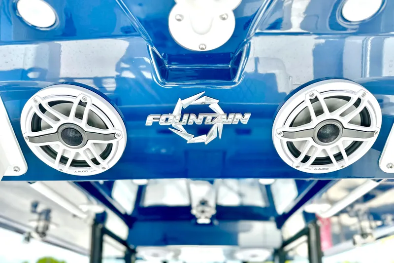 Slide: The Image of 2023 Fountain 38 Center Console boat with JL Audio speakers, blue exterior. - 11
