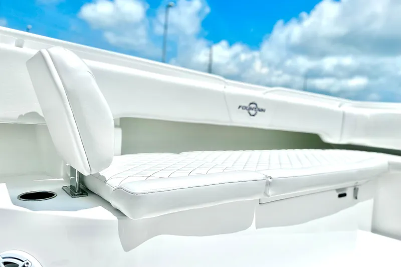 Slide: The Image of 2023 Fountain 38 Center Console boat with white cushioned seating under a blue sky. - 14