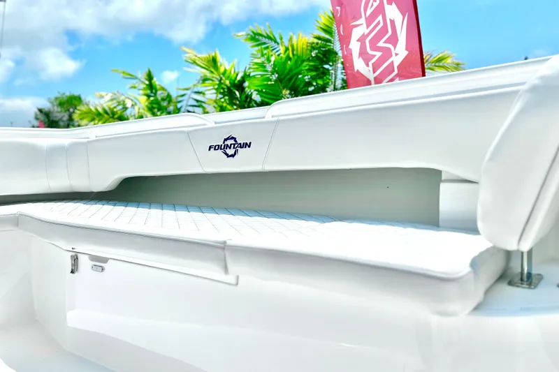 Slide: The Image of 2023 Fountain 38 Center Console boat interior with white seating, tropical background. - 15