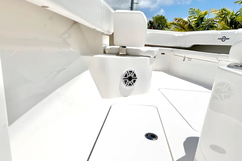 Slide: The Image of 2023 Fountain 38 Center Console boat interior with white seating and speaker. - 20