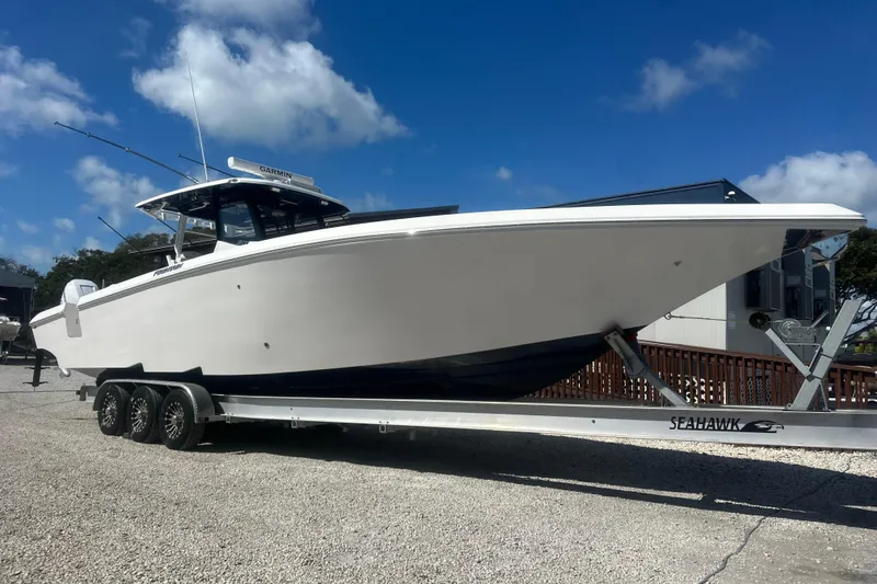 Slide: The Image of 2023 Fountain 38 Center Console boat on trailer under clear blue sky. - 21