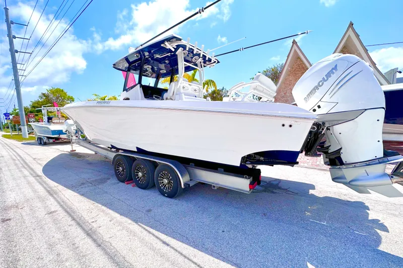 Slide: The Image of 2023 Fountain 38 Center Console boat with dual Mercury engines on a trailer. - 3