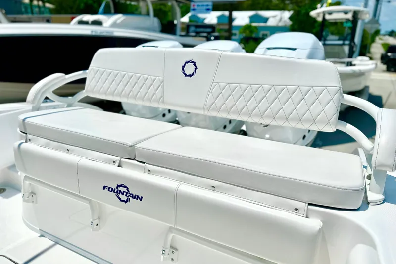 Slide: The Image of 2023 Fountain 38 Center Console boat with white cushioned seating and logo detail. - 9