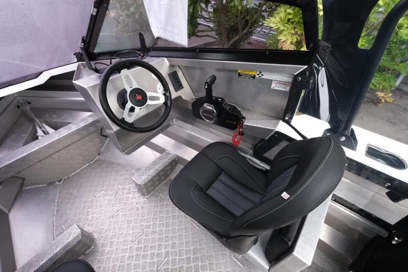 Slide: The Image of 2019 Stabicraft 1550 Fisher boat interior with steering wheel and seat. - 10