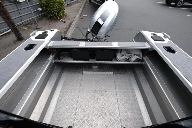 Slide: The Image of 2019 Stabicraft 1550 Fisher boat interior with motor, featuring aluminum flooring. - 11