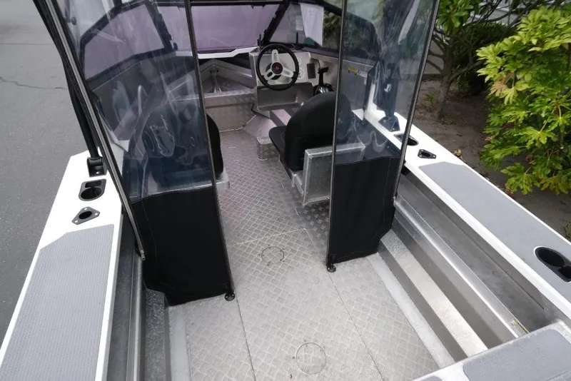 Slide: The Image of 2019 Stabicraft 1550 Fisher boat interior with steering wheel and seating. - 7