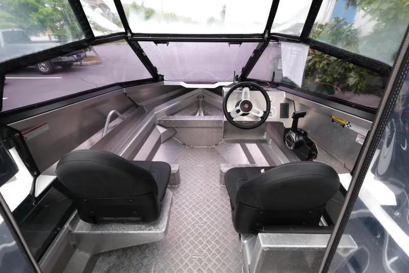 Slide: The Image of 2019 Stabicraft 1550 Fisher boat interior with dual seats and steering console. - 8